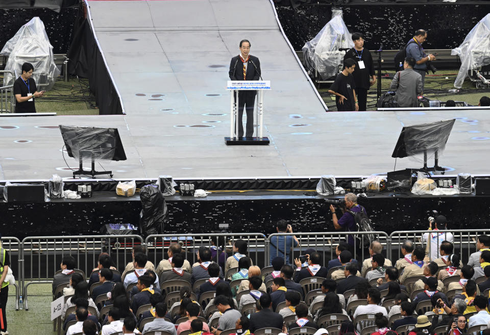 South Korean Prime Minster Han Duck-soo speaks during the closing ceremony of the World Scout Jamboree at the World Cup Stadium in Seoul, South Korea, Friday, Aug. 11, 2023. Flights and trains resumed and power was mostly restored Friday after a tropical storm blew through South Korea, which was preparing a pop concert for 40,000 Scouts whose global Jamboree was disrupted by the weather. (Korea Pool via AP)