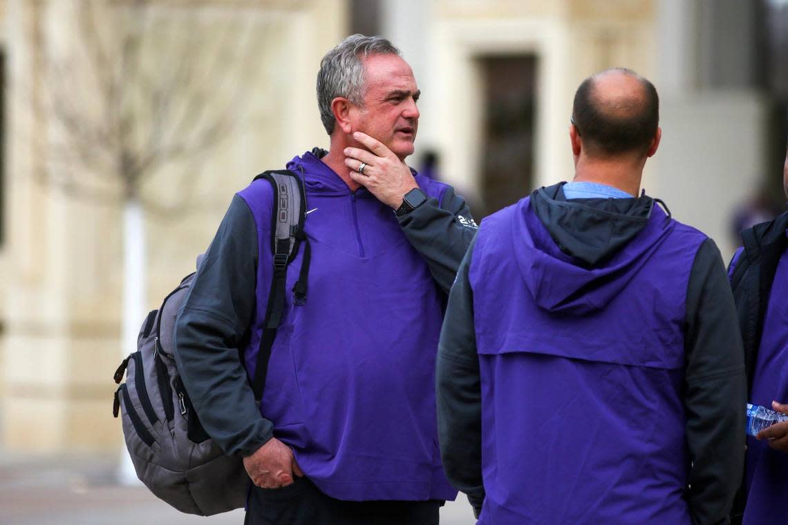 TCU head coach Sonny Dykes chats with support staff before leaving with his team to head to the College Football Championships, outside of the Amon G. Carter Stadium in Fort Worth on Friday, Jan. 6, 2023. As the buses left, fans lined nearby streets to cheer them on.