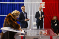 A woman casts her ballot during parliamentary elections in Warsaw, Poland, Sunday, Oct. 15, 2023. The outcome of Sunday's election will determine whether the right-wing Law and Justice party will win an unprecedented third straight term or whether a combined opposition can win enough support to oust it. (AP Photo/Michal Dyjuk)