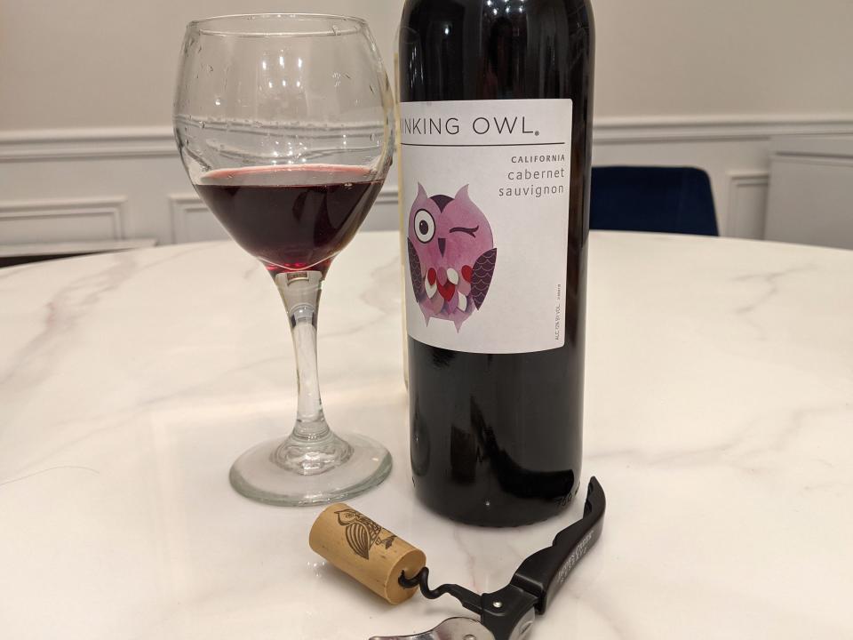bottle of red winking owl wine from Aldi and a glass of it