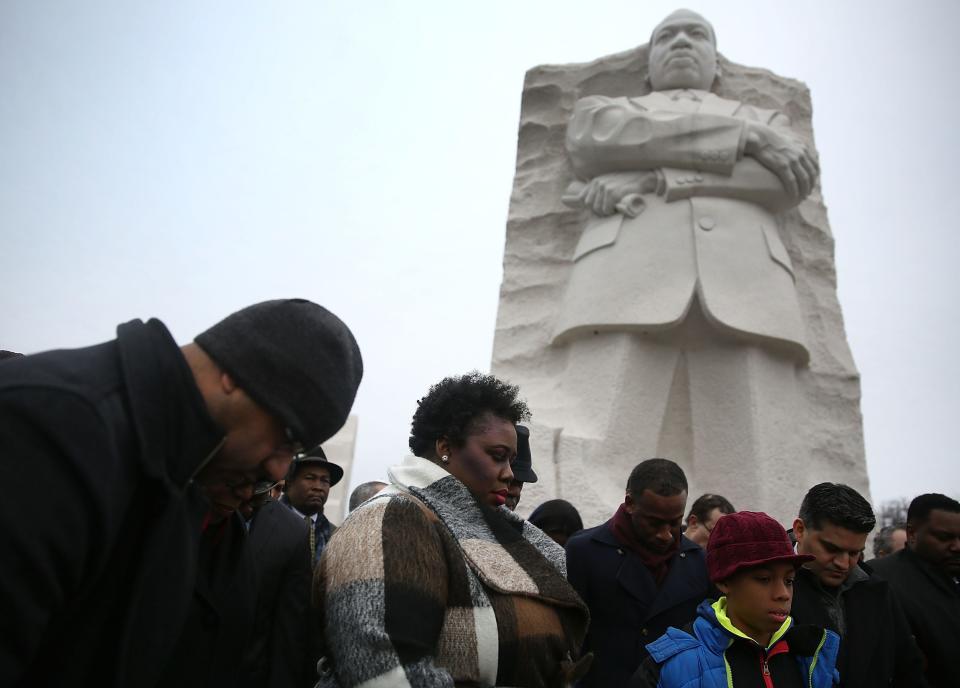 WASHINGTON, DC - JANUARY 16: People pray together in front of the Martin Luther King Jr. memorial on the day that honors him on January 16, 2017 in Washington, DC. Martin Luther King day is a national holiday that observes the birthday of the civil rights icon and is a way to remember all that he accomplished. (Photo by Joe Raedle/Getty Images)