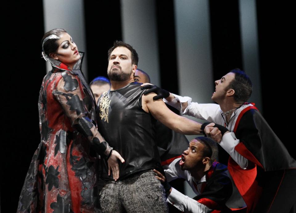 In this Feb. 24, 2012 photo, the evil Queen of Damascus, Armida, played by Elza Van Den Heever, left, tries to seduce Rinaldo, played by David Daniels, as her Furies surround Rinaldo, during the final dress rehearsal at the Lyric Opera of Chicago's production of Rinaldo. (AP Photo/Charles Rex Arbogast)