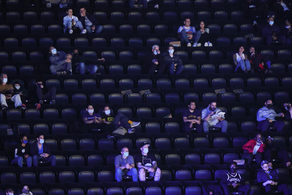 Fans watch during the first half of an NBA basketball game between the Brooklyn Nets and the San Antonio Spurs at Barclays Center Wednesday, May 12, 2021, in New York. (AP Photo/Frank Franklin II)