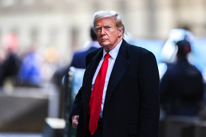 Trump in a suit with tie walking, expression serious