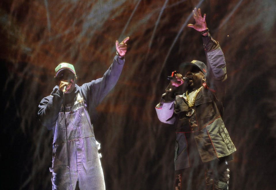 Andre 3000, left, and Big Boi of hip hop group Outkast perform behind a screen during their headlining set on the first day of the 2014 Coachella Music and Arts Festival on Friday, April 11, 2014, in Indio, Calif. (Photo by Chris Pizzello/Invision/AP)