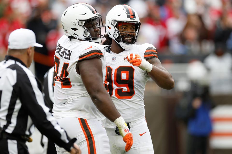 Browns defensive tackle Dalvin Tomlinson (94) celebrates with defensive end Za'Darius Smith (99) during the second half against the San Francisco 49ers Sunday, Oct. 15, 2023, in Cleveland.