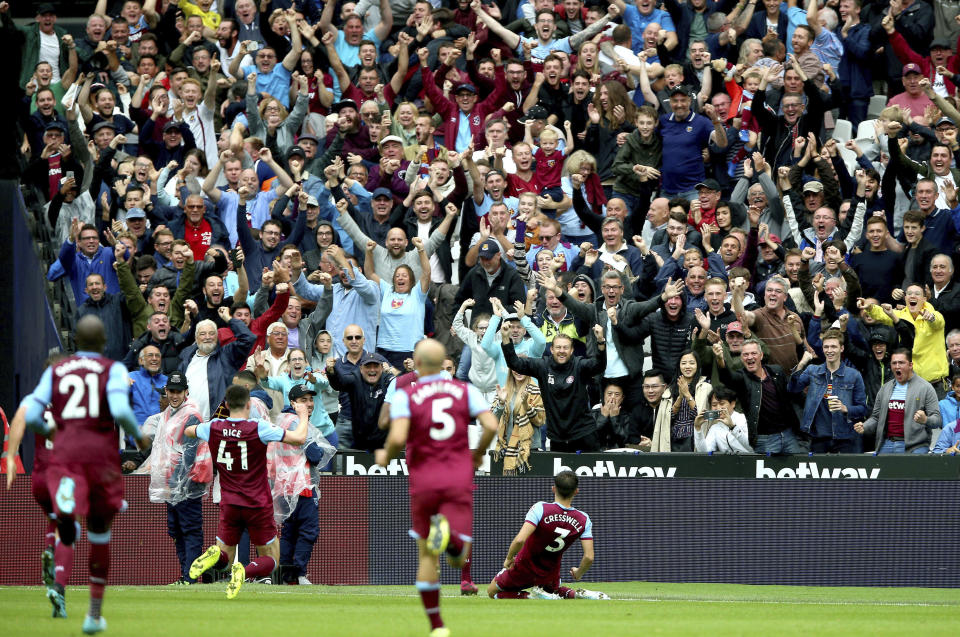 West Ham United's Aaron Cresswell, right, celebrates scoring against Manchester United during the English Premier League soccer match at London Stadium, Sunday Sept. 22, 2019. (Nigel French/PA via AP)