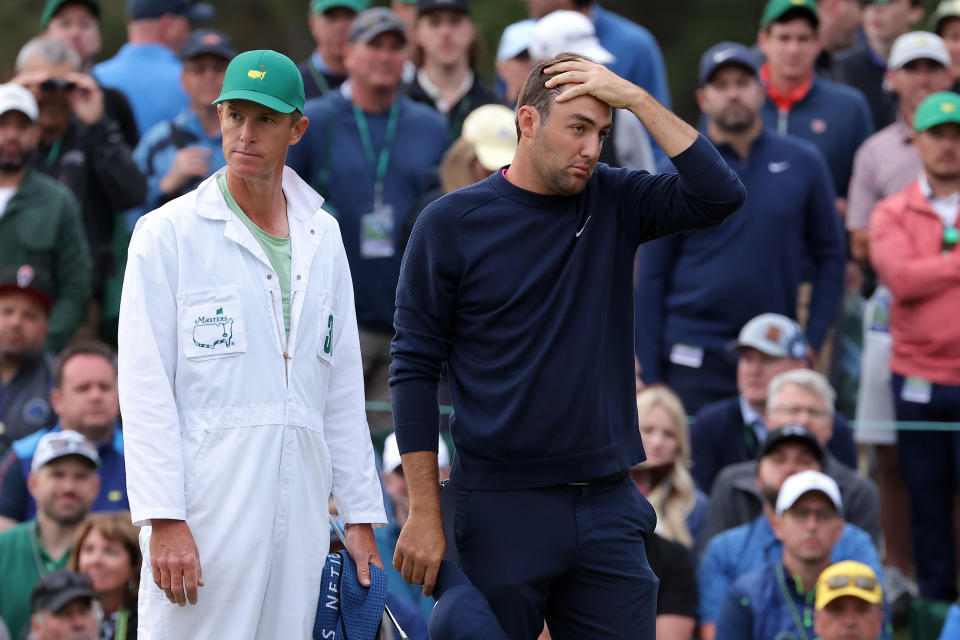 AUGUSTA, GEORGIA - APRIL 08: Scottie Scheffler and caddie Ted Scott look on from the 18th green after finishing their round during the second round of The Masters at Augusta National Golf Club on April 08, 2022 in Augusta, Georgia. (Photo by Jamie Squire/Getty Images)