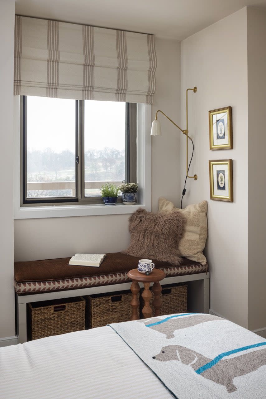 a bed with a blanket and a table with a basket on it