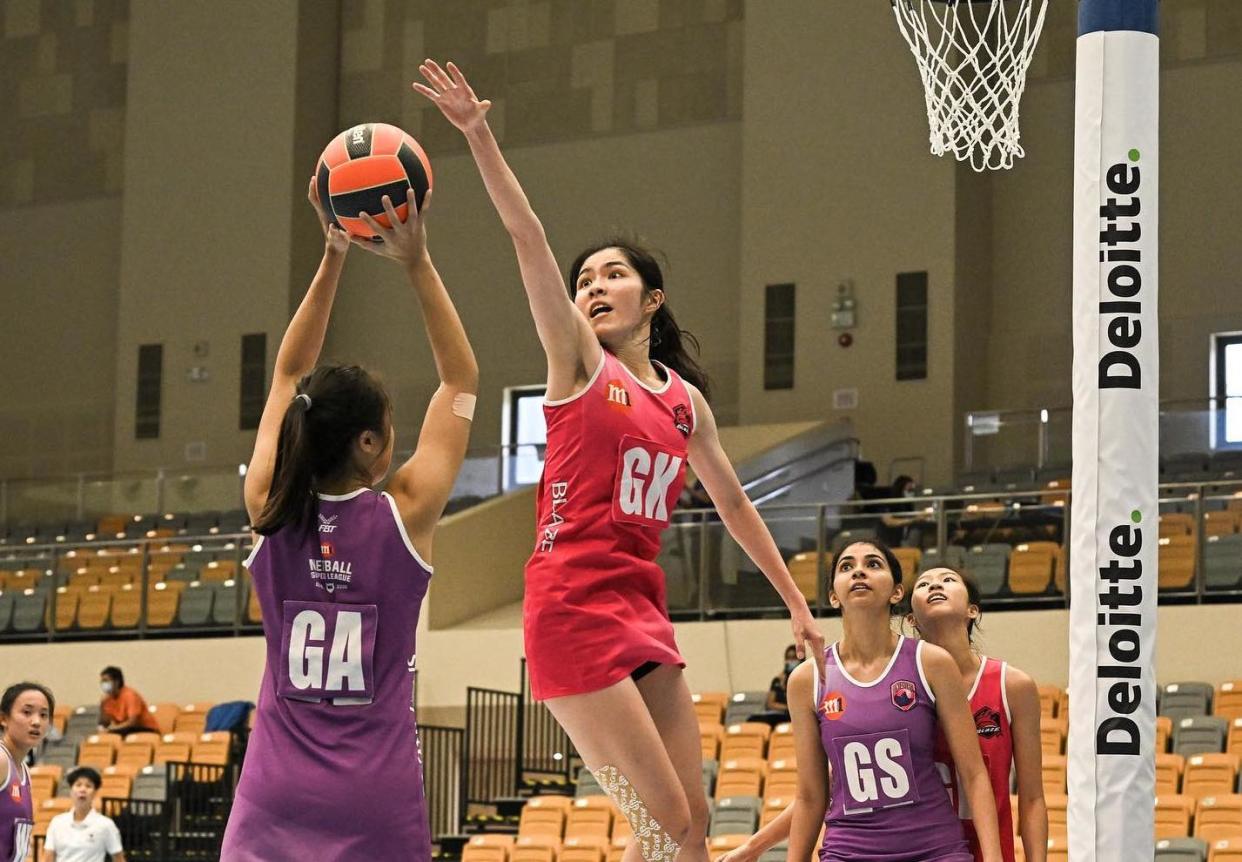 Netballers from Blaze Dolphins (red jersey) and Sneaker Stingrays compete in the opening match of the 2022 Deloitte Netball Super League. (PHOTO: Netball Singapore)