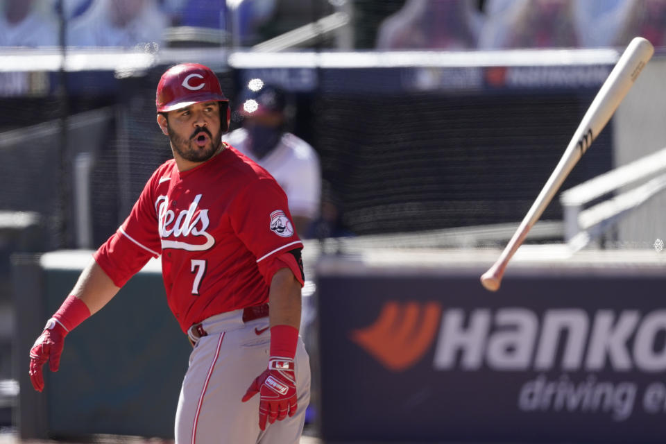 Cincinnati Reds third baseman Eugenio Suarez (7) tosses his bat after drawing a walk to load the bases in 11th inning during Game 1 of a National League wild-card baseball series against the Atlanta Braves, Wednesday, Sept. 30, 2020, in Atlanta. (AP Photo/John Bazemore)