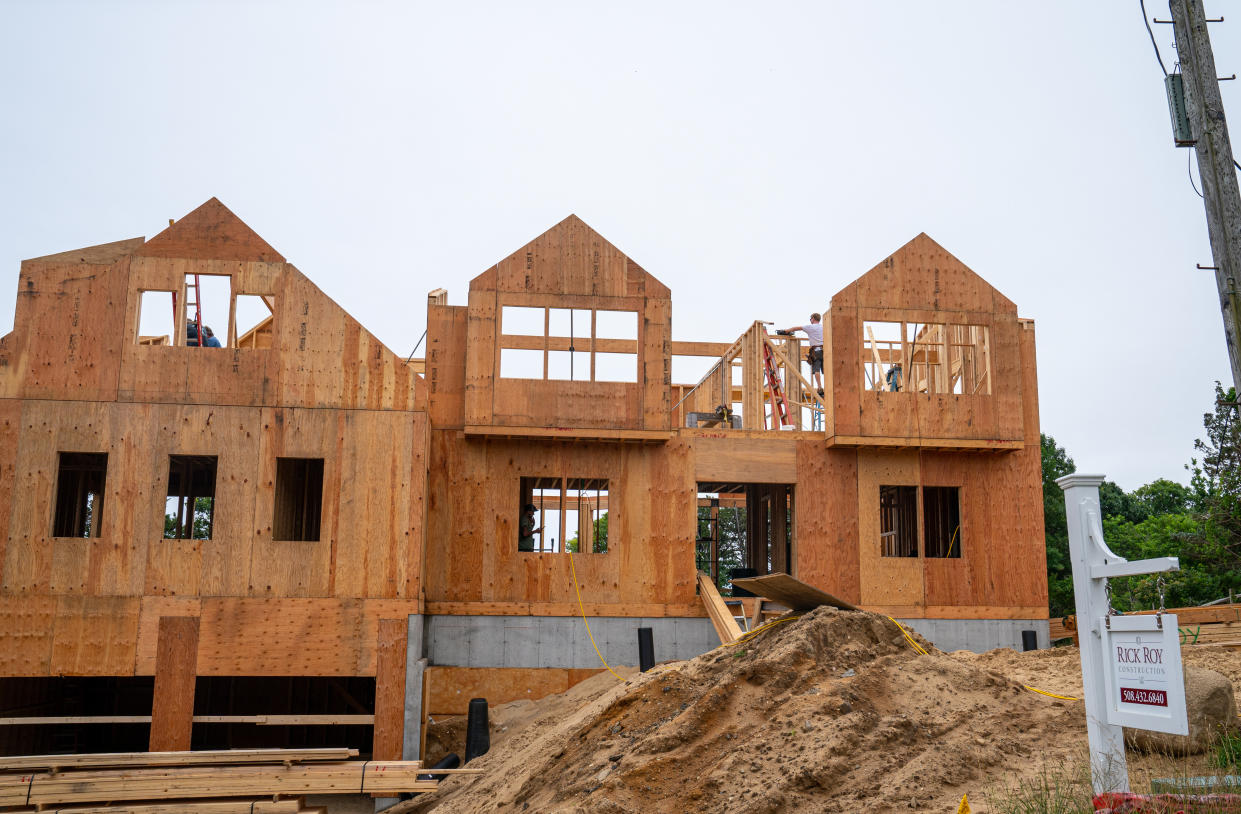 ORLEANS, MASSACHUSETTS - JULY 13: Carpenters frame a new home July 13, 2021 on Cape Cod in Orleans, Massachusetts. Median sale prices for a single-family house on Cape Cod in Chatham, Massachusetts have increased 218% over prices in 2020.  (Photo by Robert Nickelsberg/Getty Images)