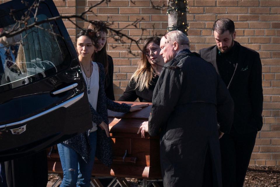 Relatives and loved ones gather around the casket of Michigan State University shooting victim Alexandria Verner, 20, after a funeral mass at Guardian Angels Catholic Church in Clawson, Saturday, Feb. 18, 2023.