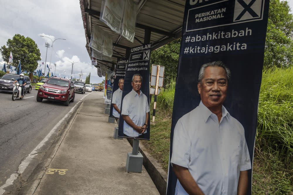 Election poster featuring Perikatan Nasional chairman Tan Sri Muhyiddin Yassin are seen in Keningau, Sabah September 24, 2020. — Picture by Firdaus Latif