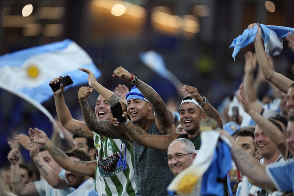 FILE - Argentina soccer fans cheer before the World Cup group C soccer match between Poland and Argentina at the Stadium 974 in Doha, Qatar, Wednesday, Nov. 30, 2022. (AP Photo/Natacha Pisarenko, File)