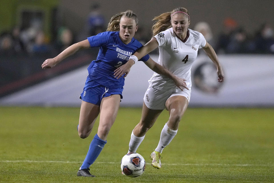 BYU's Olivia Smith (2) battles for the ball against Florida State's Kristina Lynch (4) during the second half of the NCAA College Cup women's soccer final, Monday, Dec. 6, 2021, in Santa Clara, Calif. (AP Photo/Tony Avelar)