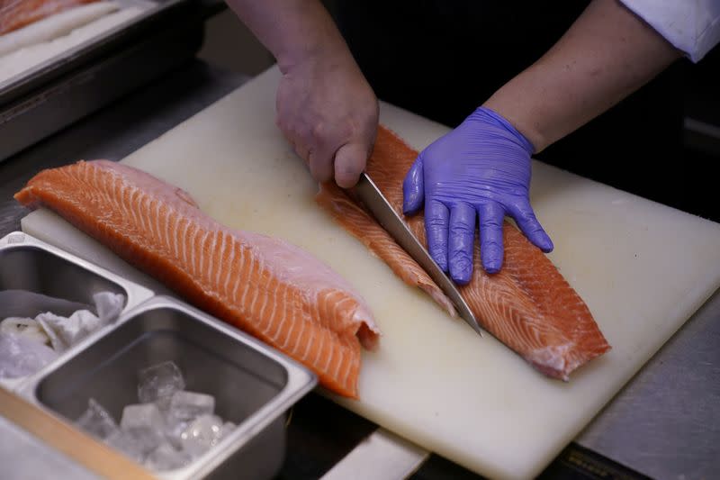 Chef and owner Austin Hu cooks a salmon at Heritage by Madison restaurant, in Shanghai