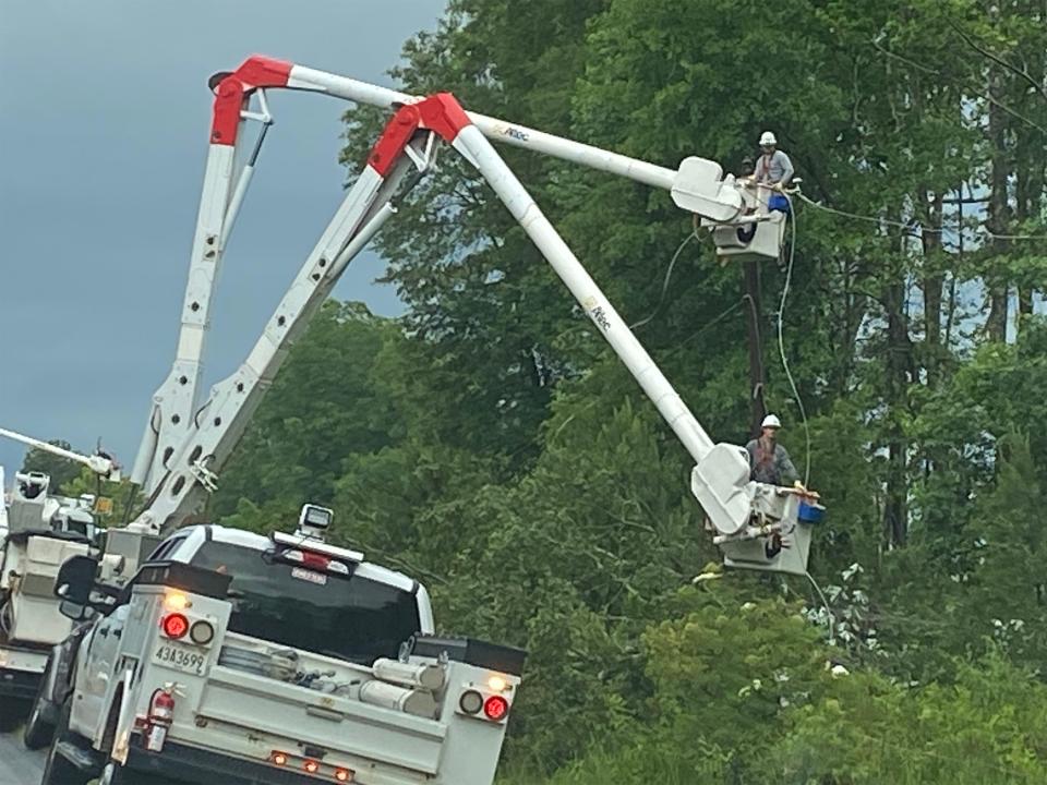 Workers restore power lines damaged by storms near Opelika on Thursday, June 15, 2023.