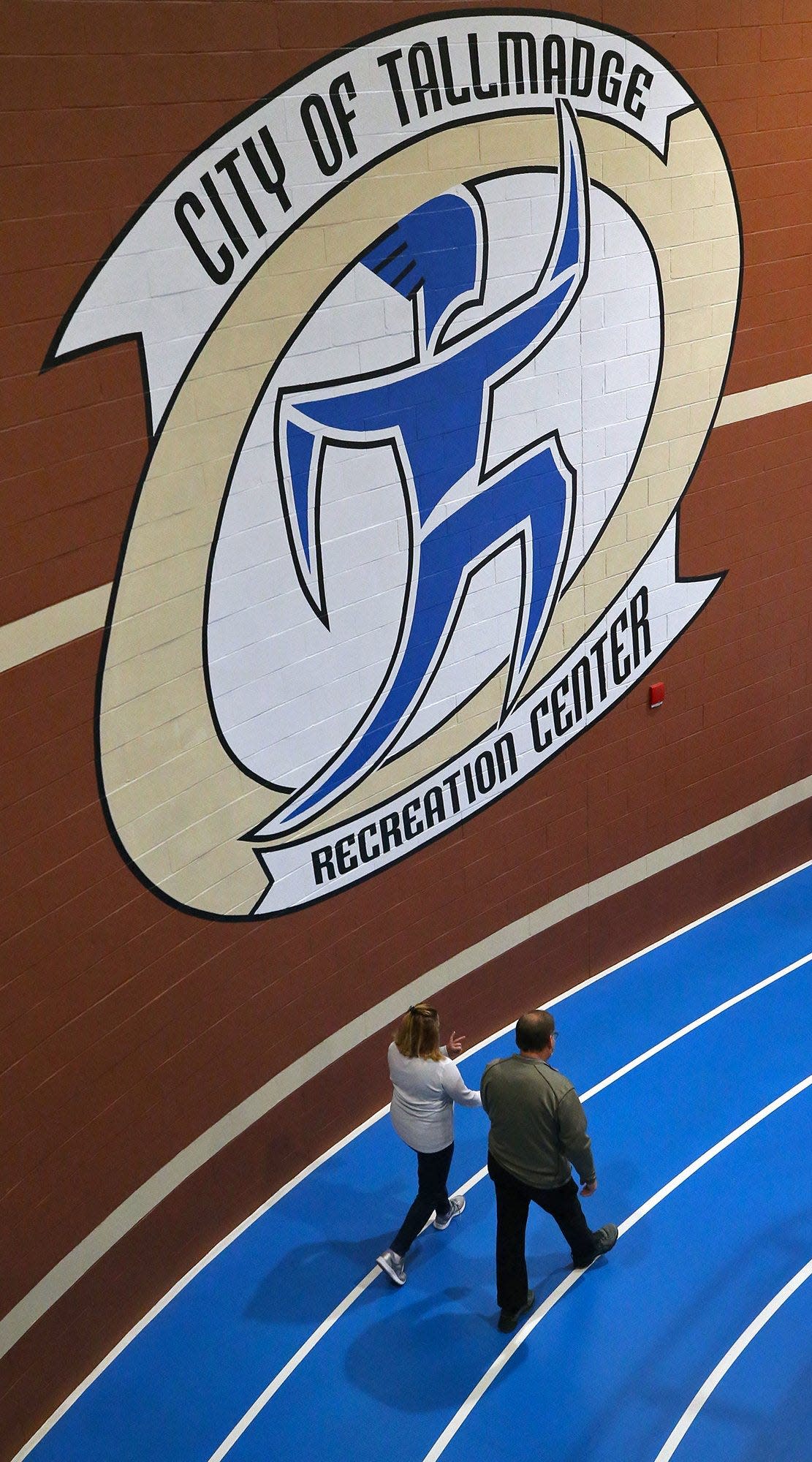 A couple walks together on the indoor track at the Tallmadge Recreation Center, Saturday, Jan. 9, 2021, in Tallmadge, Ohio. [Jeff Lange/Beacon Journal]