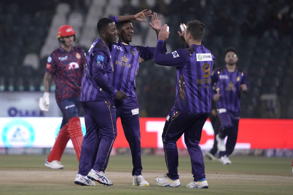 Quetta Gladiators' Akeal Hosein, third left, celebrates with teammates after taking the wicket of Islamabad United' Alex Hales during the Pakistan Super League T20 cricket match between Islamabad United and Quetta Gladiators, in Lahore, Pakistan Thursday, Feb. 22, 2024. (AP Photo/K.M. Chaudary)