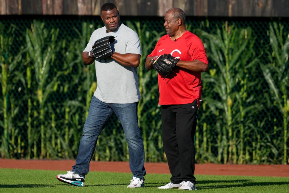 Hall of Fame baseball player and former Cincinnati Reds center fielder Ken Griffey Jr., left, asks his dad and fellow  Hall of Fame player Ken Griffey Sr., if heÕd like to play catch  before a baseball game between the Chicago Cubs and the Cincinnati Reds, Thursday, Aug. 11, 2022, at the MLB Field of Dreams stadium in Dyersville, Iowa. 