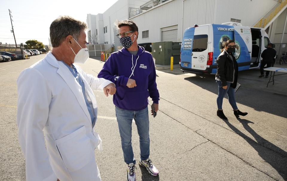 Dr. Steven Florman medical director of Stacy Medical Center, left, gets an elbow bump from Russell Barnett.