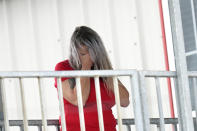 Marion Cuyler, fiancée of missing crew member Chaz Morales, talks on her cell phone at a fire station where family members of 12 people missing from a capsized oil industry vessel have been gathering, Thursday, April 15, 2021, in Port Fourchon, La. The lift boat capsized in the Gulf of Mexico during a storm on Tuesday, killing one with 12 others still missing. (AP Photo/Gerald Herbert)