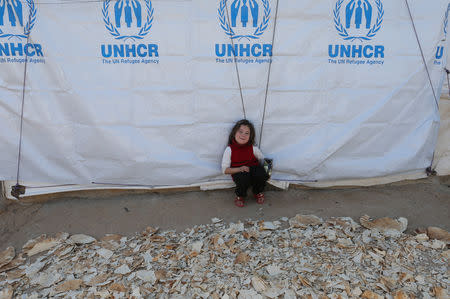 A Syrian refugee girl sits next to dried bread at a refugee camp in Akkar, northern Lebanon, November 27, 2018. Picture taken November 27, 2018. REUTERS/Mohamed Azakir