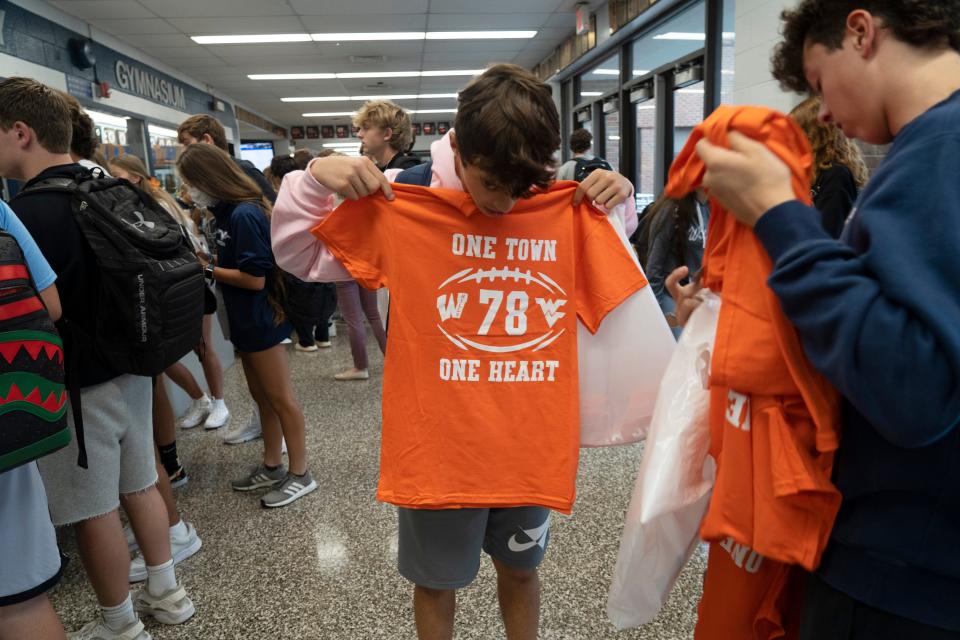 Students Kyle Crystal and Joseph Barone look at new T-shirts that they purchased to benefit the Rocco Sivolella Memorial Scholarship at Wayne Valley High School on Sept. 22.