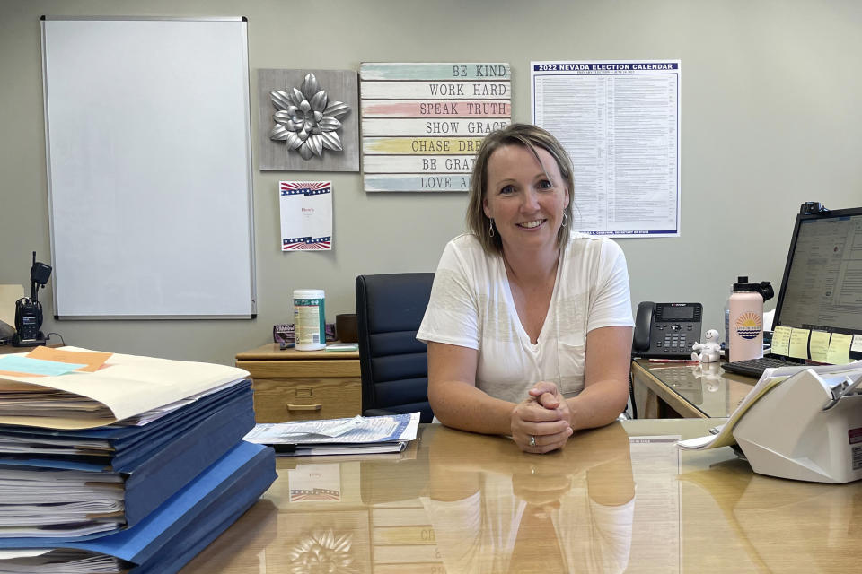 Clerk-recorder Aubrey Rowlatt poses in her office in Carson, City, Nev., on July 8, 2022. Rowlatt was elected as Carson City's clerk-recorder in 2018, planning to serve two or three terms. Now she's retiring after one term due to a host of duties that has led to burnout. (AP Photo/Gabe Stern)