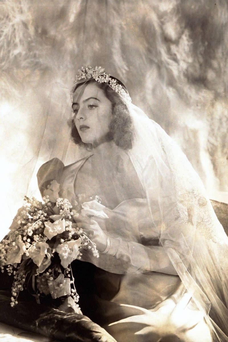 <p> In 1938, socialite Jane Alva Johnson posed for her wedding day portrait with her veil&apos;s blusher covering her face. The bride, who married John Hemingway, wore a Directoire style satin wedding gown with large puffy sleeves. </p>