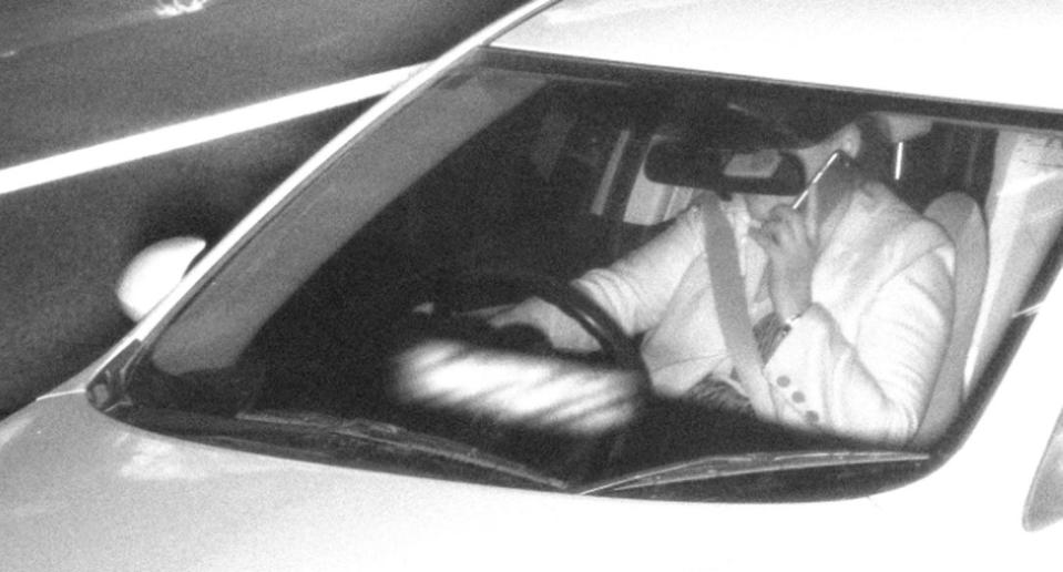 A driver photographed driving while speaking on a mobile phone.