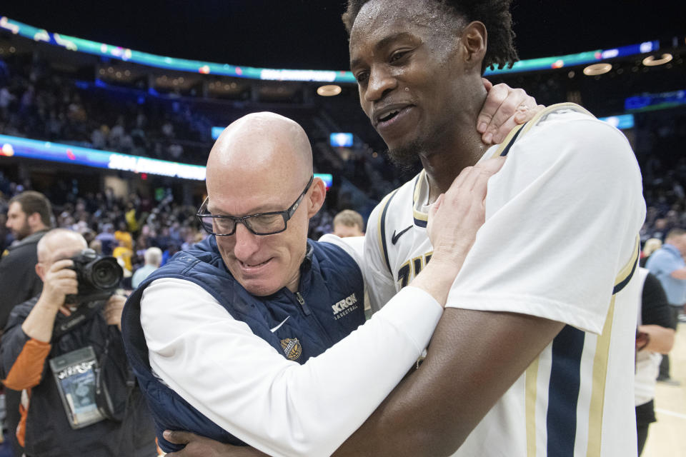 Akron head coach John Groce, left, celebrates Akron's victory over Kent State with Akron's Ali Ali at the end of an NCAA college basketball game in the championship of the Mid-American Conference tournament, Saturday, March 16, 2024, in Cleveland. (AP Photo/Phil Long)