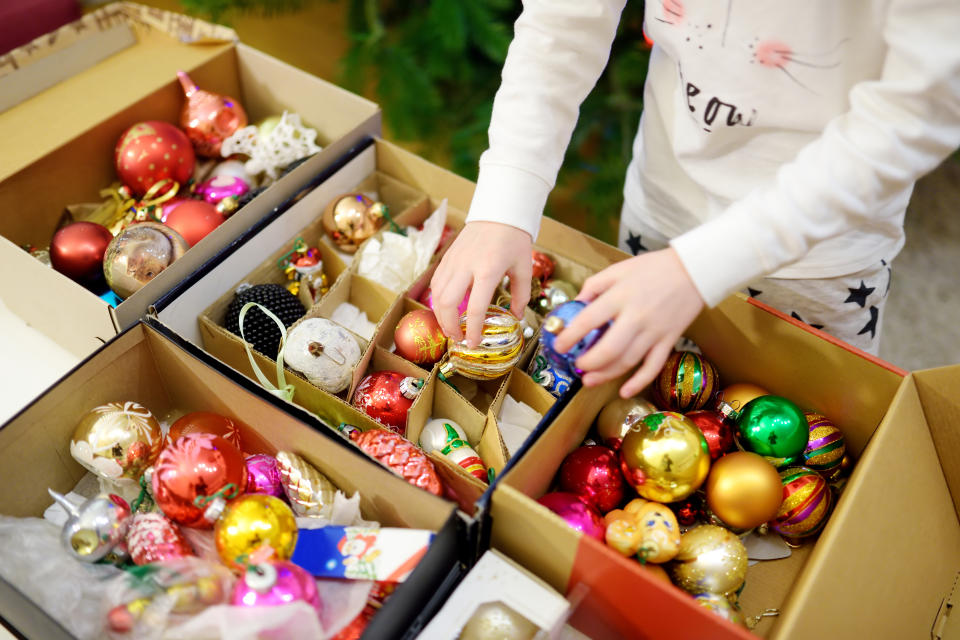 Variety of colorful Christmas baubles in a boxes. Trimming the Christmas tree. Celebrating Xmas at home.