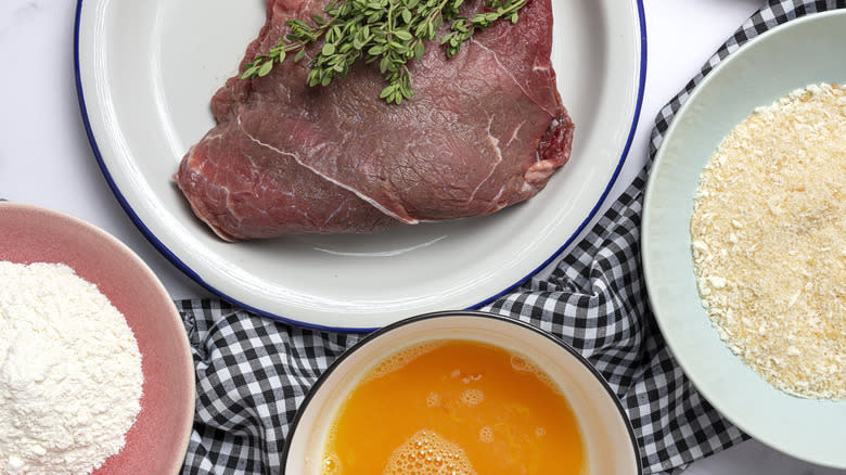 Steak milanesa ingredients on table