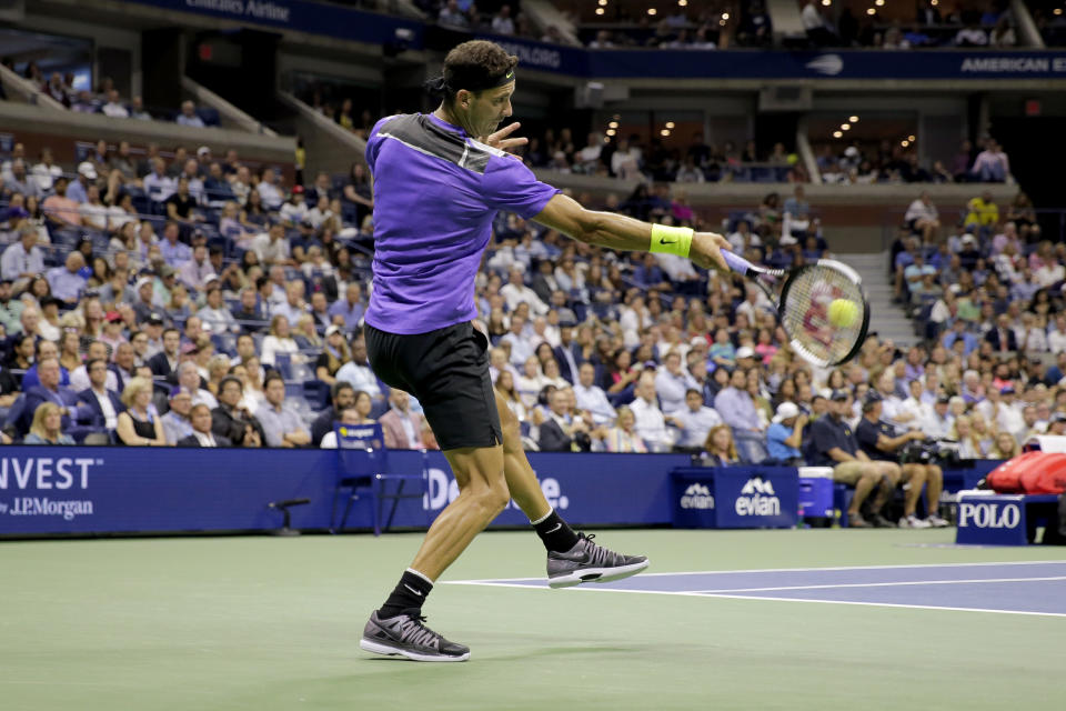 Grigor Dimitrov, of Bulgaria, hits a forehand to Roger Federer, of Switzerland, during the quarterfinals of the U.S. Open tennis tournament Tuesday, Sept. 3, 2019, in New York. (AP Photo/Seth Wenig)