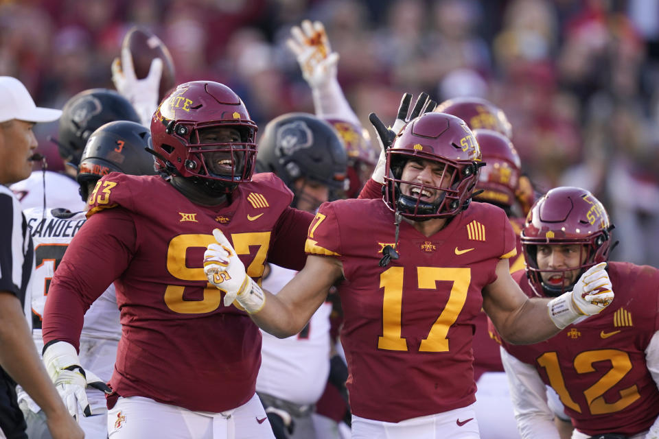 Iowa State defensive back Beau Freyler (17) celebrates with teammate Iowa State defensive tackle Isaiah Lee (93) after a tackle during the second half of an NCAA college football game against Oklahoma State, Saturday, Oct. 23, 2021, in Ames, Iowa. Iowa State won 24-21. (AP Photo/Charlie Neibergall)