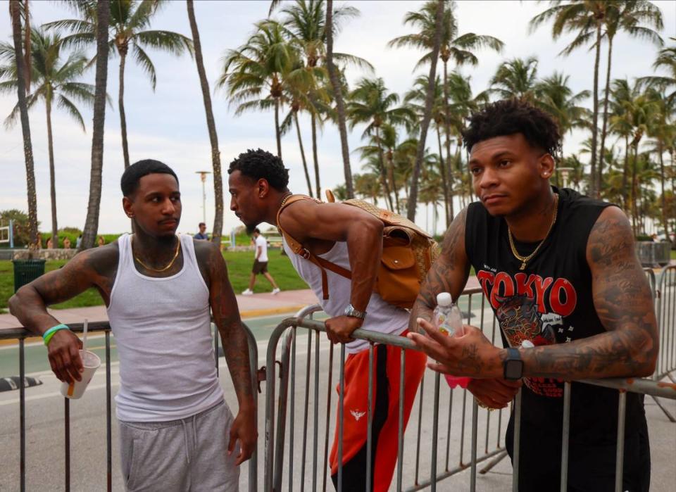 Von Garside, center, passes the time with a quick set of dips while the group traveled from Atlanta to South Beach for spring break. K. Jones, 31, left, Von Garside, 25, and Brampton Everson, 26, right, hung out on Ocean Drive on Sunday, March 10, 2024.