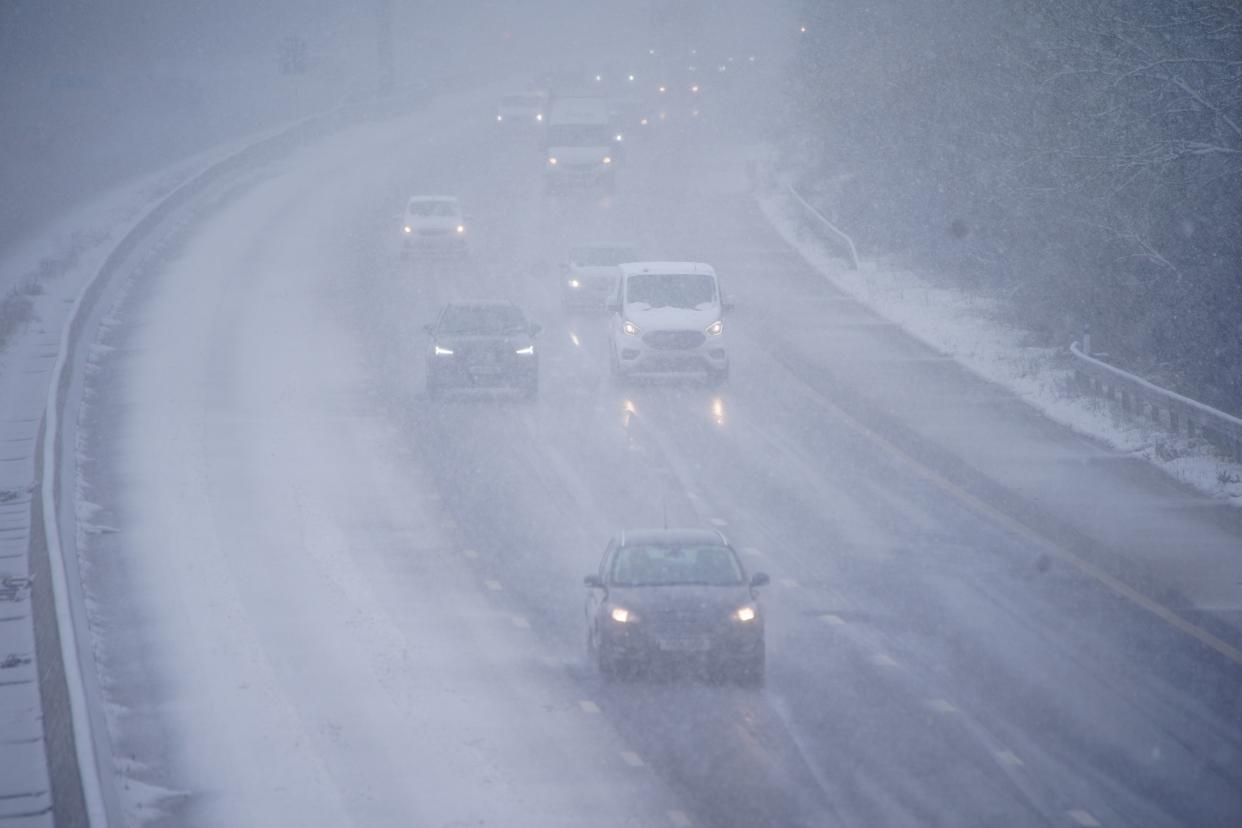Cars driving through snow on the northbound carriageway of the M5 motorway near Taunton, which has been reduced to two lanes due to snow (Ben Birchall/PA Wire)