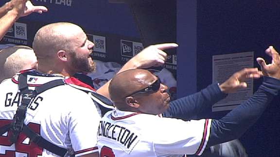 Evan Gattis inadvertently tosses Cory Rasmus' first career strikeout ball  into stands