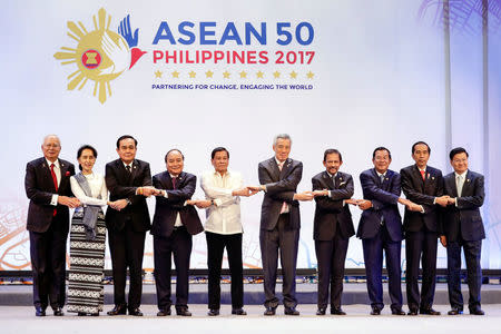 Association of Southeast Asian Nations (ASEAN) leaders link arms during the opening ceremony of the 30th ASEAN Summit in Manila, Philippines April 29, 2017. L-R: Malaysian Prime Minister Najib Razak, Myanmar State Counsellor Aung San Suu Kyi, Thai Prime Minister Prayuth Chan-ocha, Vietnamese Prime Minister Nguyen Xuan Phuc, Philippine President Rodrigo Duterte, Singapore's Prime Minister Lee Hsien Loong, Sultan Hassanal Bolkiah of Brunei Darussalam, Cambodian Prime Minister Hun Sen, Indonesian President Joko Widodo and Laos' Prime Minister Thongloun Sisoulith. REUTERS/Mark Crisanto/Pool