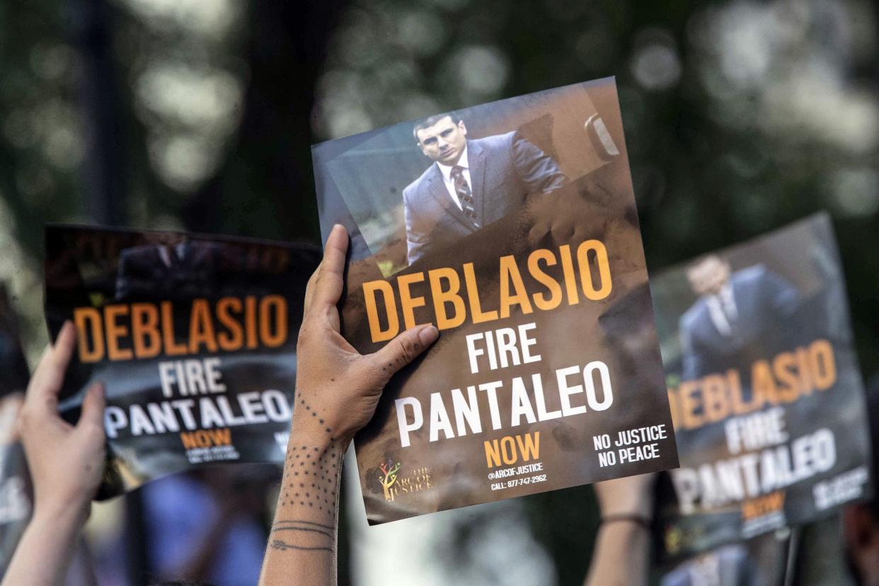 FILE - Demonstrators rally with signs calling on New York Mayor Bill de Blasio to fire police Officer Daniel Pantaleo, who caused the death of Eric Garner with a chokehold, Friday, Aug. 2, 2019, in New York. 