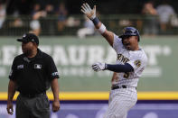 Milwaukee Brewers' Eduardo Escobar, right, reacts after hitting a two-RBI single during the second inning of a baseball game against the New York Mets, Sunday, Sept. 26, 2021, in Milwaukee. Escobar advanced to second base on a throwing error. (AP Photo/Aaron Gash)