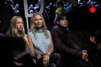 Lila Moss, left, and Kate Moss, centre, attend the Dior Menswear ready-to-wear Fall-Winter 2024-2025 collection presented in Paris, Friday, Jan. 19, 2024. (AP Photo/Christophe Ena)