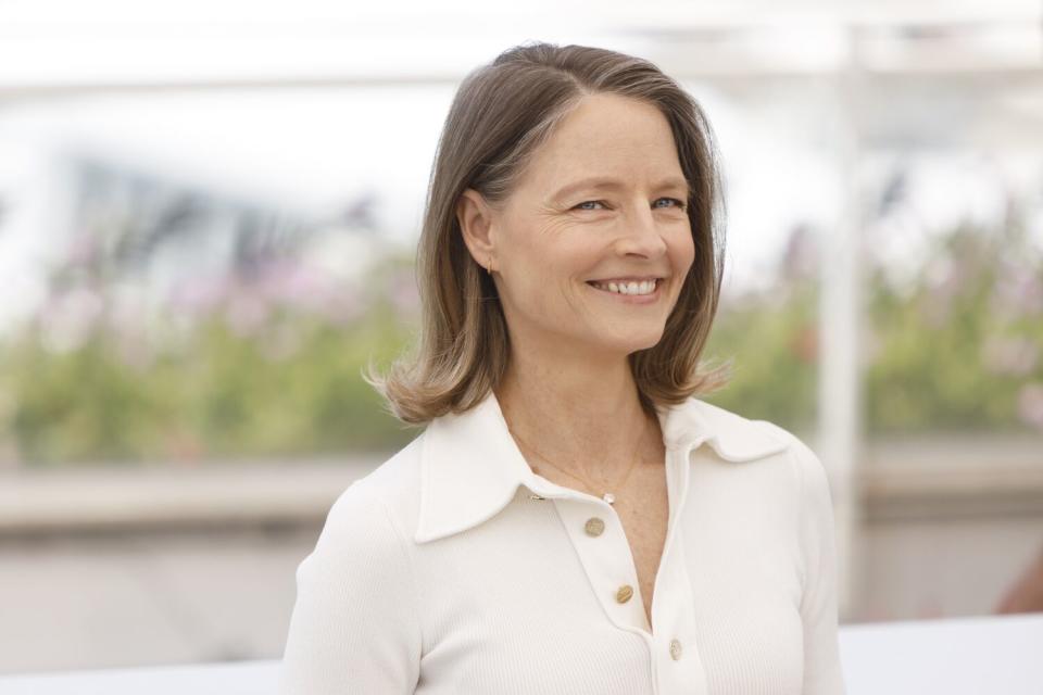 A smiling woman in a white shirt.