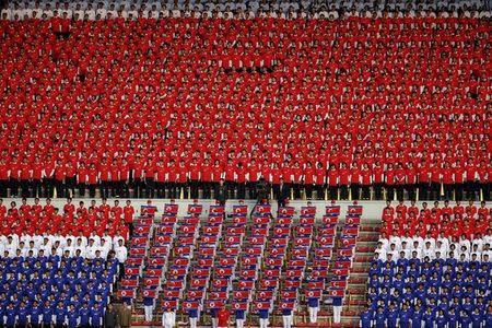 North Korean fans in national colours sing their national anthem before their team's preliminary 2018 World Cup and 2019 AFC Asian Cup qualifying soccer match against Philippines at the Kim Il Sung Stadium in Pyongyang October 8, 2015. REUTERS/Damir Sagolj