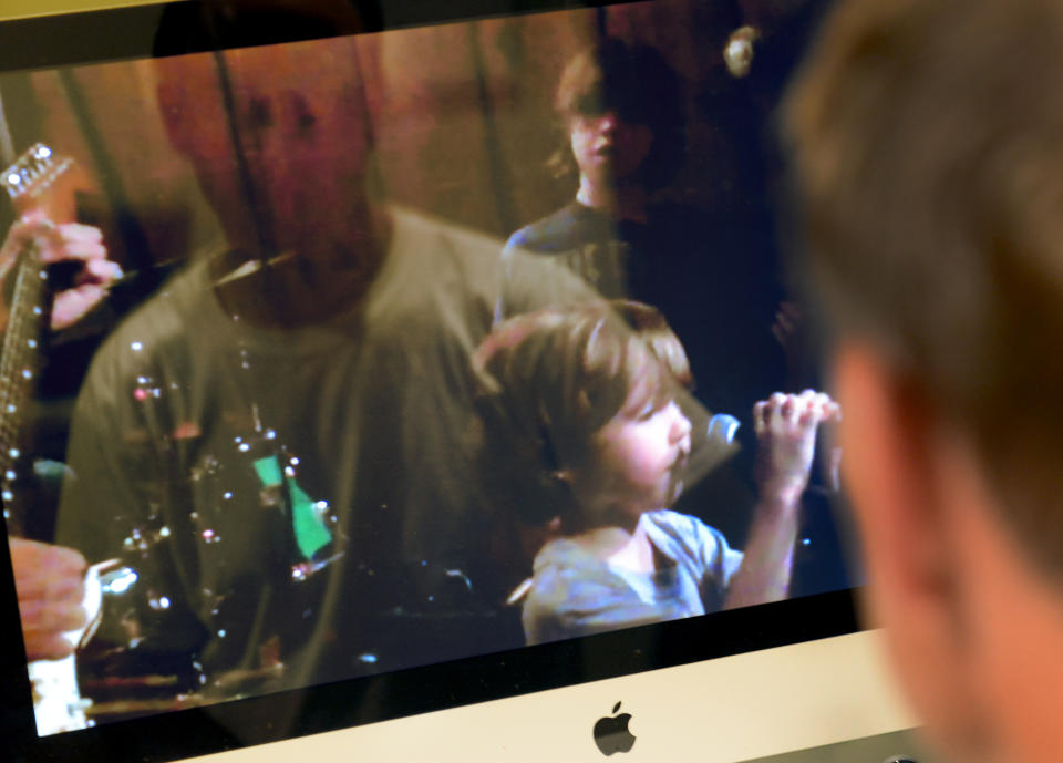 Mark Barden watches a video of his late son, Daniel, on a computer screen.