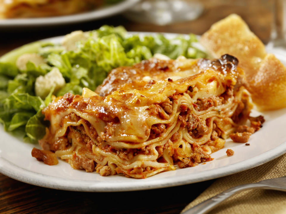 A large portion of lasagna and salad.