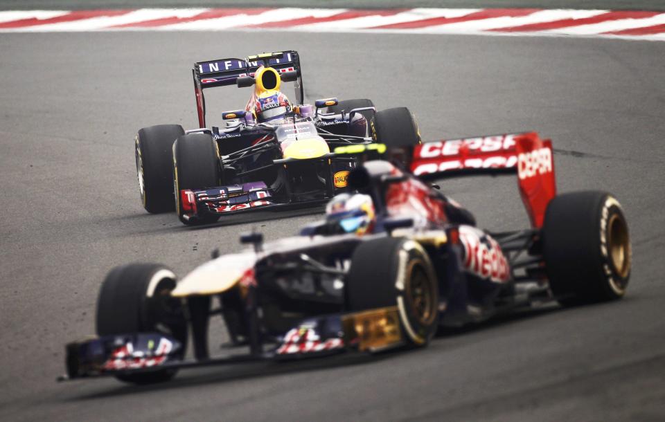 Toro Rosso Formula One driver Daniel Ricciardo of Australia (front) drives ahead of Red Bull Formula One driver Mark Webber of Australia during the second practice session of the Indian F1 Grand Prix at the Buddh International Circuit in Greater Noida, on the outskirts of New Delhi, October 25, 2013. REUTERS/Anindito Mukherjee (INDIA - Tags: SPORT MOTORSPORT F1)