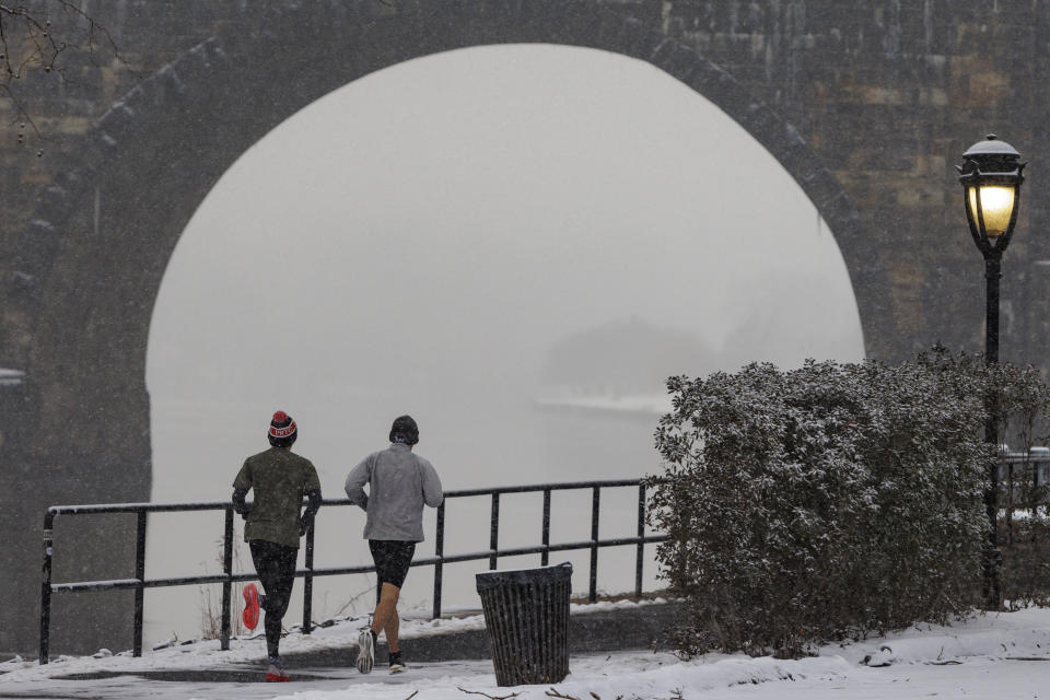 Joggers run along Kelly Drive in Philadelphia on Friday, Jan. 19, 2024. Philadelphia and region is preparing for snow. (Alejandro A. Alvarez/The Philadelphia Inquirer via AP)